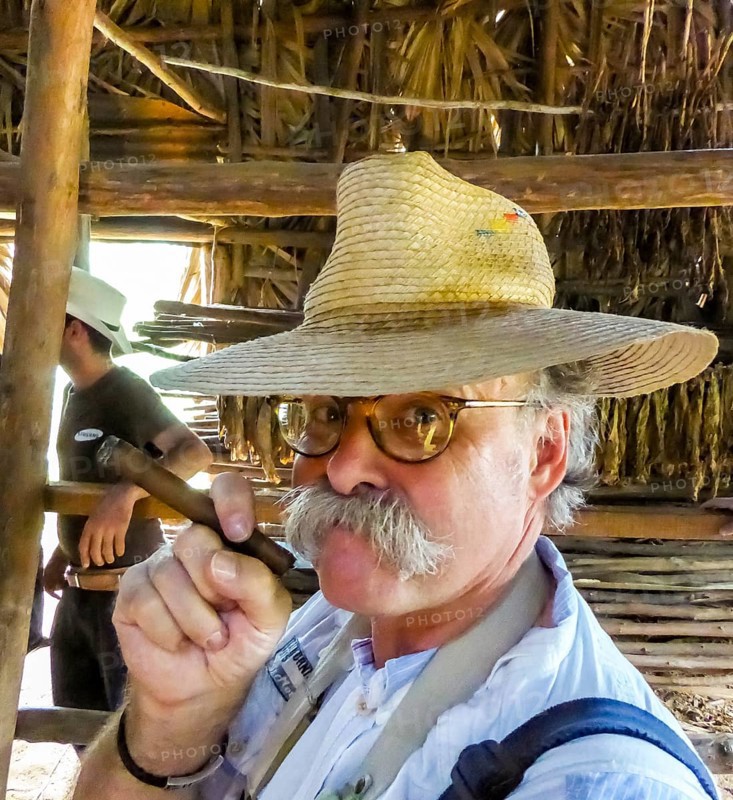 Hans Blossey Tourist smokes a Havana cigar, tobacco farm in the Vinalestal, Viñales, Cuba, Pinar del Río