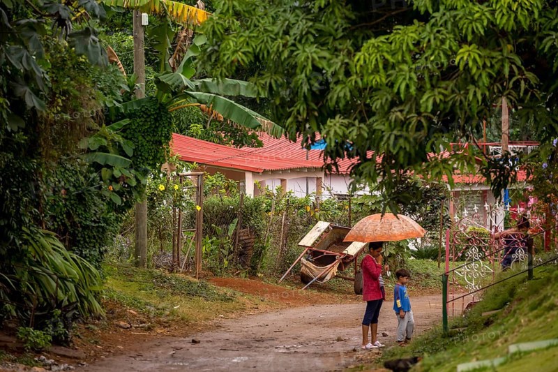 Street scene with woman and child and umbrella, Viñales, Cuba, Pinar del Río, Cuba, Viñales, Pinar del Río