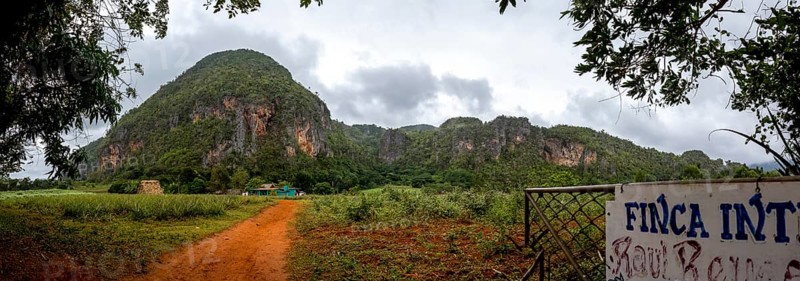 Red earth, finca, farmhouse below the overgrown hills in the Vinales Valley, Viñales, Cuba, Pinar del Río, Cuba, Viñales, Pinar del Río