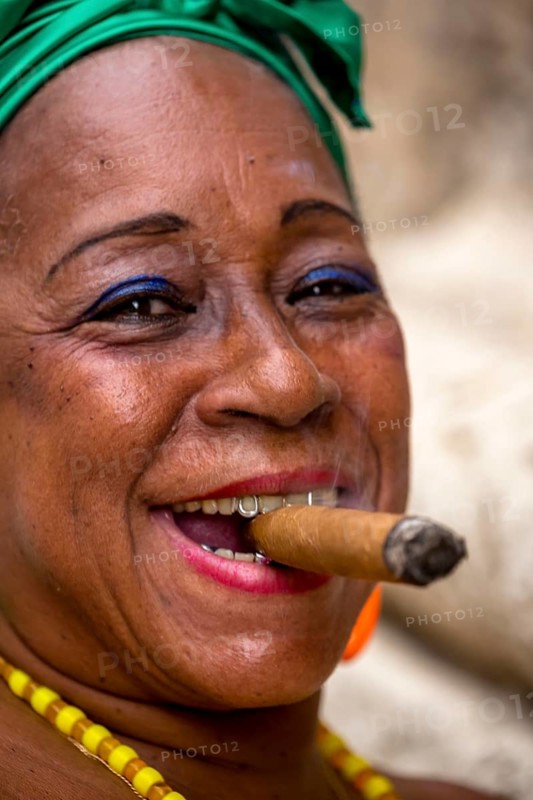 Old Cuban woman with green hair bow smokes a Havana cigar, Cuban woman with cigar and lacquered fingernails with the Cuban flag, Cuban flag, nail polish, La Habana, Cuba, Caribbean, Central America, Cuba, Europe, aerial view, birds-eyes view, aerial photography, aerial photography, overview, bird's eye view