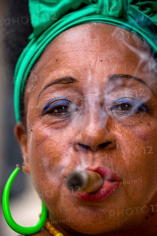 Old Cuban woman with green hair bow smokes a Havana cigar, Cuban woman with cigar and lacquered fingernails with the Cuban flag, Cuban flag, nail polish, La Habana, Cuba, Caribbean, Central America, Cuba, Europe, aerial view, birds-eyes view, aerial photography, aerial photography, overview, bird's eye view