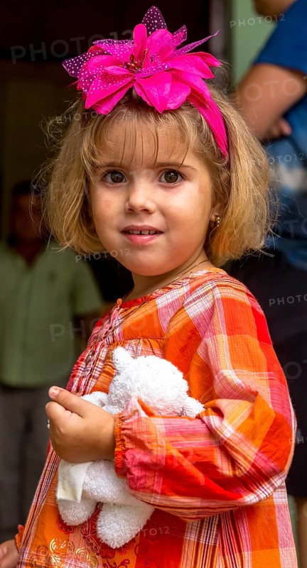 Little Cuban girl with white teddy bear and pink bow in her hair, Pink bow, Viñales, Cuba, Pinar del Río, Cuba, Viñales, Pinar del Río