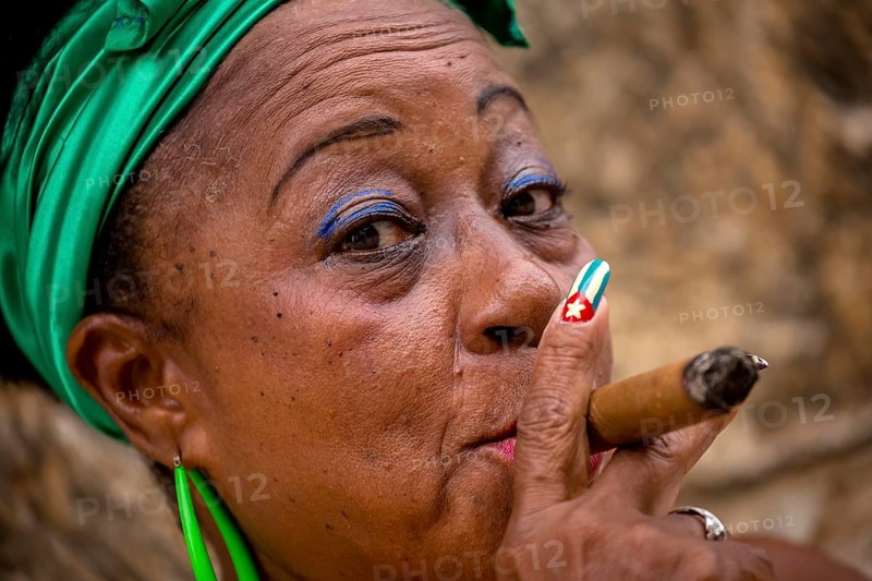Old Cuban woman with green hair bow smokes a Havana cigar, Cuban woman with cigar and lacquered fingernails with the Cuban flag, Cuban flag, nail polish, La Habana, Cuba, Caribbean, Central America, Cuba, Europe, aerial view, birds-eyes view, aerial photography, aerial photography, overview, bird's eye view