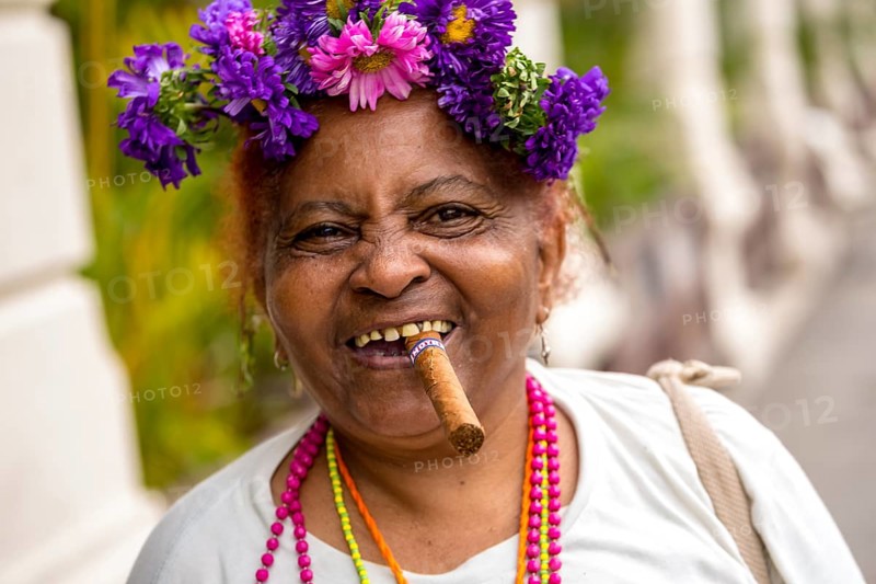 Old Cuban woman with flowers and cigar posing for a tip for tourists, La Habana, Havana, Cuba, Cuba, Europe, aerial photo, birds-eyes view, aerial photography, aerial photography, overview, bird's eye view