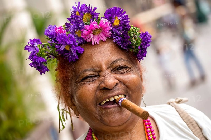 Old Cuban woman with flowers and cigar posing for a tip for tourists, La Habana, Havana, Cuba, Cuba, Europe, aerial photo, birds-eyes view, aerial photography, aerial photography, overview, bird's eye view