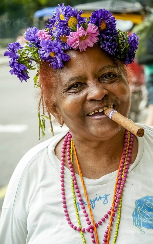 Old Cuban woman with flowers in her hair smoking a cigar and post for the photographer, La Habana, Havana, Cuba, Cuba, Europe, aerial view, birds-eyes view, aerial photography, aerial photography, overview, bird's eye view