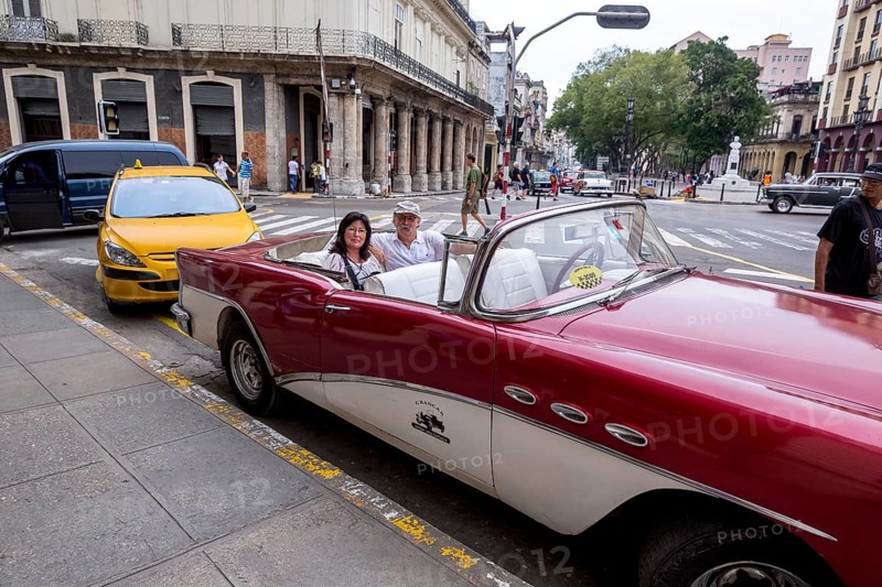 Tourists in a red convertible, red vintage convertible in the street scene, old American street cruiser on the streets of Havana, taxi, Havana, Cuba, La Habana, Cuba, Europe, aerial view, birds-eyes view, aerial photography, aerial photography, overview, bird's eye view