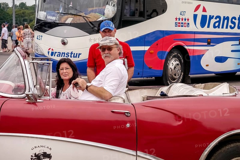 Tourists in a red convertible, red vintage convertible in the street scene, old American road cruisers on the streets of Havana, taxi, Havana, Cuba, Europe, aerial view, birds-eyes view, aerial photography, aerial photography, overview, bird's eye view