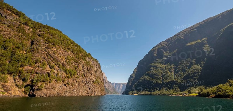 Fjord, Nærøyfjord, rock faces, mountains, blue sky, Styvi, Sogn og Fjordane, Norway, Scandinavia, Europe, NOR, travel, tourism, destination, sightseeing, sea voyage, Hurtigruten, Hurtigruten trip, tourism, Norwegian, Scandinavian, tourist, cruise, adventure trip, waters, water, shipping, seafaring, sightseeing, hills, trees, forests, sky