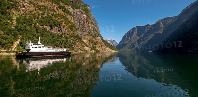 Excursion ship on a fjord, Flåm, Gudvangen, rock walls, trees, blue sky, Sogn og Fjordane, Norway, Scandinavia, Europe, NOR, travel, tourism, destination, sightseeing, sea voyage, Hurtigruten, Hurtigruten trip, tourism, Norwegian, Scandinavian, tourist, cruise, adventure trip, mountains, tourist trip, shipping, river, stones, tourist ship, water, waters