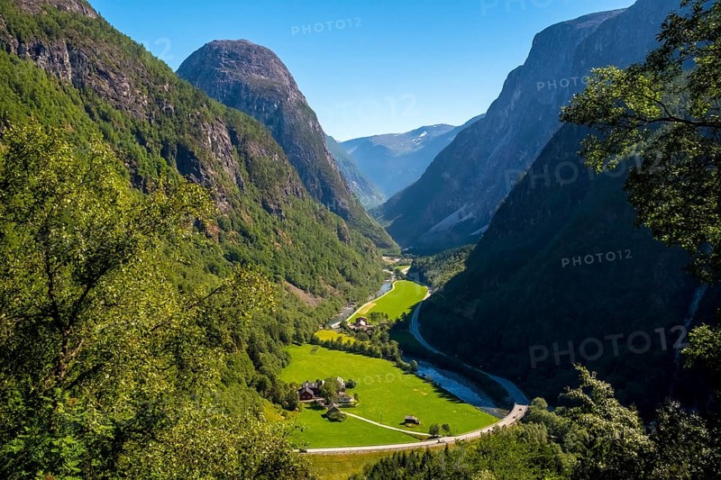 Valley, green meadows, path, rock faces, blue sky, Stalheim, Hordaland, Norway, Scandinavia, Europe, NOR, travel, tourism, destination, sightseeing, sea voyage, Hurtigruten, Hurtigruten trip, tourism, Norwegian, Scandinavian, tourist, cruise, adventure trip, landscape, mountains, road, houses, sky