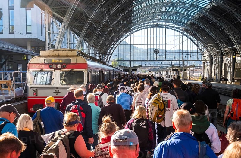 Tourists at Bergen railway station, glass dome roof, train, Bergen, Hordaland, Norway, Scandinavia, Europe, NOR, travel, tourism, destination, sightseeing, sea voyage, Hurtigruten, Hurtigruten trip, tourism, Norwegian, Scandinavian, tourist, cruise, adventure trip, train journey, people, hall, station hall, railway, information boards, passenger transport, local passenger transport, crowds, crowds of tourists