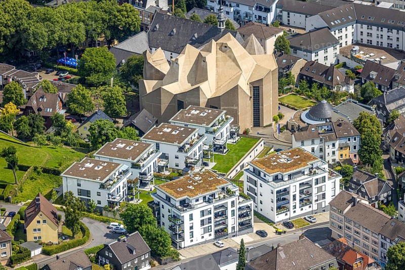 Aerial view, Mariendom and futuristic roof construction of the catholic church, Franciscan monastery Hardenberg with catholic parish church St. Mariä Empfängnis, Rundbau Pfarrzentrum Glocke, construction site with new construction of apartment buildings on the former hospital site, Neviges, Velbert, Ruhr area, North Rhine-Westphalia, Germany, construction work, construction area, building site, building plots, construction project, construction site, DE, Europe, aerial view, aerial photography, aerial photography, new construction, overview, bird's-eye view, birds-eyes view, overview