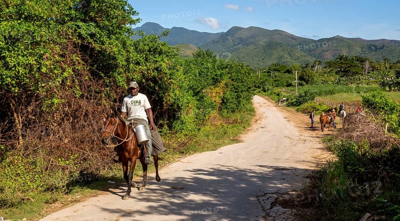 Cuban rider on a horse with a milk can in Valle de los Ingenios, Trinidad, Cuba, Sancti Spíritus, Cuba, Sancti Spíritus
