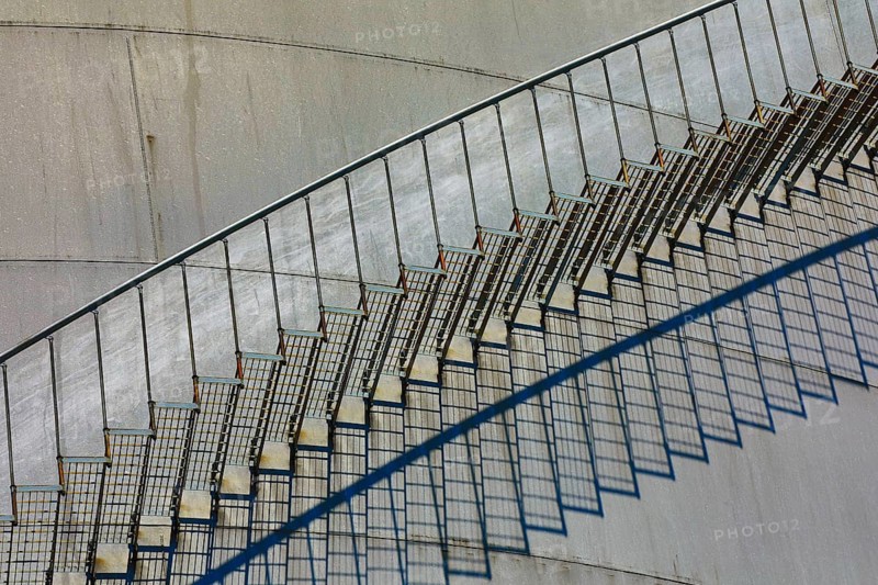Close-up of a metal staircase with detailed shadows on the tank surface, elevated tank, chemical, company, Grenzach- Wyhlen, Baden-Württemberg, Germany