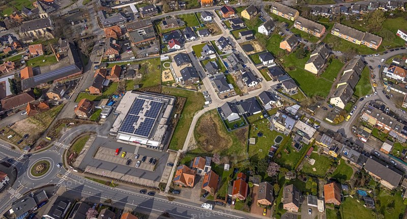 Aerial view, residential area local view district Dolberg, new REWE supermarket with solar roof, wind turbines, new roundabout Alleestraße and Uentroper Straße, new residential area Hases Wiese, catholic St. Lambertus church, Ahlen, Dolberg, Ruhr area, Germany, residential area, local view, district, REWE supermarket, solar roof, roundabout, Alleestraße, Uentroper Straße, new building, Hases Wiese, catholic, St. Lambertus Church, energy, sustainability, architecture, urban planning, infrastructure, urban, buildings, residential buildings, roads, traffic, religion, business, retail, solar energy, renewable energy, community, landscape, environment, technology