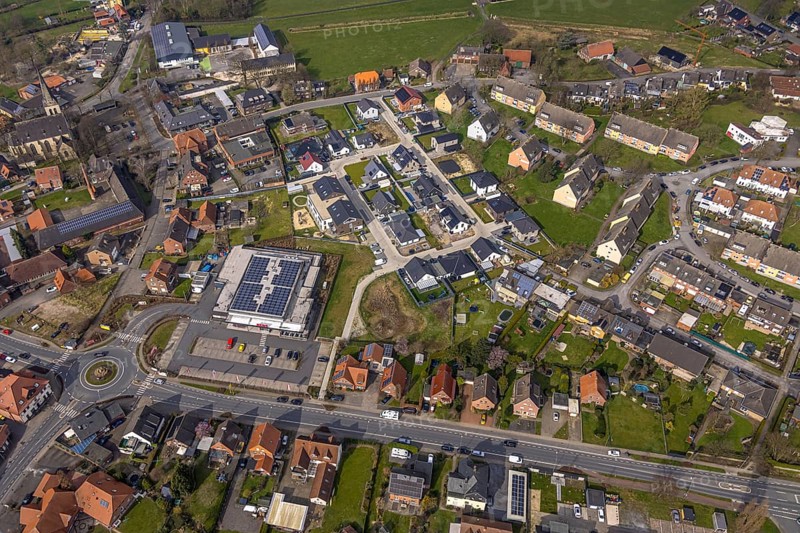 Aerial view, residential area local view district Dolberg, new REWE supermarket with solar roof, wind turbines, new roundabout Alleestraße and Uentroper Straße, new residential area Hases Wiese, catholic St. Lambertus church, Ahlen, Dolberg, Ruhr area, Germany, residential area, district, REWE supermarket, solar roof, roundabout, Alleestraße, Uentroper Straße, new building, Hases Wiese, catholic, St. Lambertus Church, architecture, infrastructure, modern, energy, sustainable, traffic, roads, buildings, church tower, residential buildings, urban, town planning, green spaces, shopping facilities, supply, community, environmentally friendly, renewable energy, district