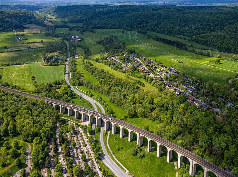 Aerial view, Altenbekener Viaduct, Adenauerstraße, railway viaduct bridge construction, also called Bekeviaduct or Great Viaduct, suburban railway, Altenbeken cemetery on the Alter Kirchweg road, residential area Am Stapelsberg, meadows and fields, Altenbeken, East Westphalia, North Rhine-Westphalia, Germany, railway viaduct, bridge construction, Bekeviaduct, Great Viaduct, Altenbeken cemetery, Alter Kirchweg, residential area, Am Stapelsberg, meadows, fields, traffic, infrastructure, railway, train, landscape, rural, architecture, building, history, transport, green spaces, nature, urbanisation, residential, cemetery, agricultural, aerial view, perspective