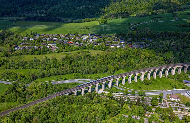 Aerial view, Altenbekener Viaduct, Adenauerstraße, railway viaduct Bridge structure, also called Bekeviaduct or Great Viaduct, suburban railway, Altenbeken cemetery and cross chapel on the Alter Kirchweg road, residential area Am Stapelsberg, meadows and fields, East Westphalia, Altenbeken, North Rhine-Westphalia, Germany, railway viaduct, bridge, Beke viaduct, Great viaduct, Altenbeken cemetery, cross chapel, Alter Kirchweg road, meadows, fields, landscape, infrastructure, traffic, railway, rail traffic, gravesites, religion, living, nature, rural, architecture, technology, transport, building, urban, green spaces, village, sky