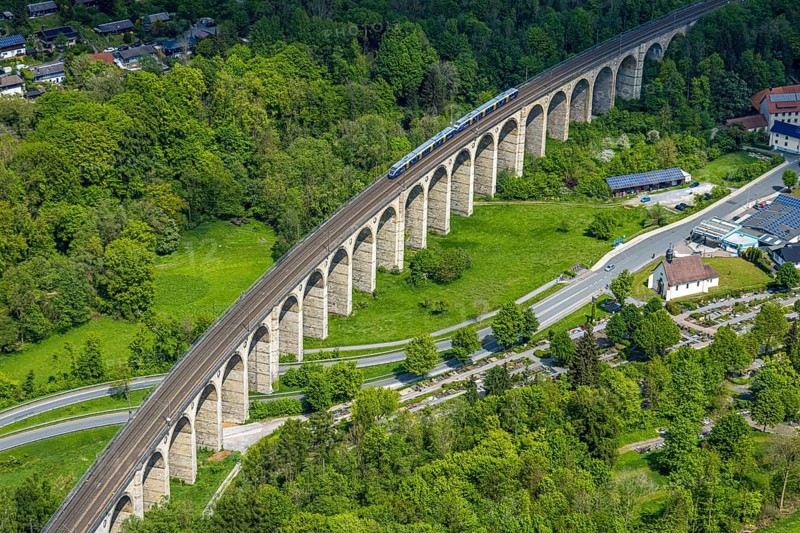Aerial view, Altenbekener Viaduct, Adenauerstraße, railway viaduct bridge construction, also called Bekeviaduct or Great Viaduct, suburban railway, Altenbeken cemetery and Kreuzkapelle on the Alter Kirchweg road, Altenbeken, East Westphalia, North Rhine-Westphalia, Germany, railway viaduct, bridge construction, Beke Viaduct, Great Viaduct, Altenbeken Cemetery, Kreuzkapelle, Alter Kirchweg, traffic, infrastructure, railway, bridge, architecture, landscape, route, transport, history, historical, structure, rails, train, top view, perspective, sky, trees, nature, city, rural, travel, technology