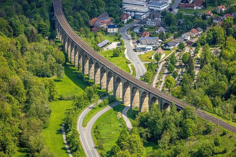 Aerial view, Altenbeken Viaduct, Adenauerstraße, railway viaduct bridge construction, also called Beke Viaduct or Great Viaduct, Altenbeken Cemetery and Kreuzkapelle Alter Kirchweg, Altenbeken, East Westphalia, North Rhine-Westphalia, Germany, railway viaduct, bridge construction, Beke Viaduct, Great Viaduct, Altenbeken Cemetery, Chapel of the Cross, Alter Kirchweg, architecture, building, infrastructure, traffic, railway, rails, history, landscape, nature, village, town, hill, trees, path, cemetery, chapel, religion, cultural heritage, technology, engineering, view, panorama, day