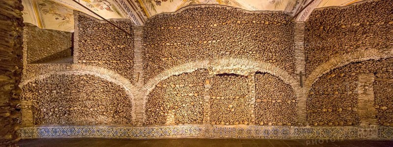Piled bones in the ossuary, Capela dos ossos parede, chapel of bones, bone chapel, ossuary in Évora, Evora, district of Évora, Portugal