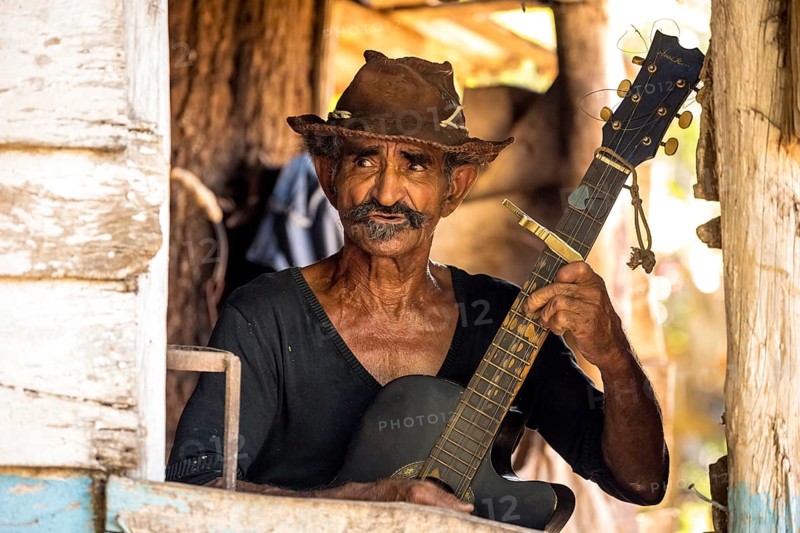 Sugar cane farmer in Valle de los Ingenios plays guitar for the tourists, Trinidad, Cuba, Sancti Spíritus, Cuba, Sancti Spíritus