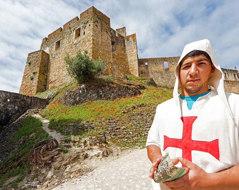 Brochure distributor dressed as Knights Templar in front of the castle, Fortress of Tomar, Castle of the Knights Templar, Templars, UNESCO cultural heritage, Tomar, Santarém district, Portugal, Europe, Convento da Ordem de Christo, Santarém district, aerial view, birds-eyes view, Travel, travel photography
