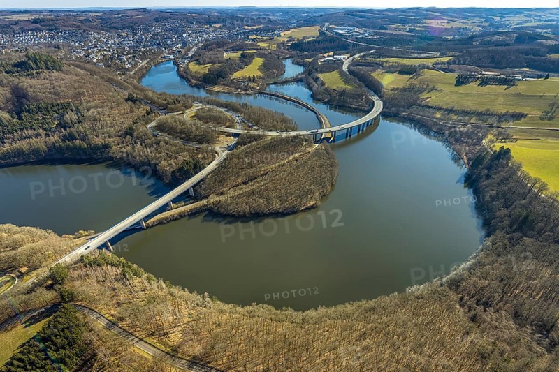 Aerial view, Biggesee with forest area, Obersee with bridge Landesstraße L512, curved bridge Bundesstraße B54, Olpe-Stadt, Olpe, Sauerland, North Rhine-Westphalia, Germany, Biggetalsperre, bridge, Bundesstraße B54, DE, Europe, shapes and colours, hilly landscape, aerial view, aerial photography, aerial photography, nature park Ebbegebirge, lake, reservoir, overview, bird's eye view, forebay, birds-eyes view, overview