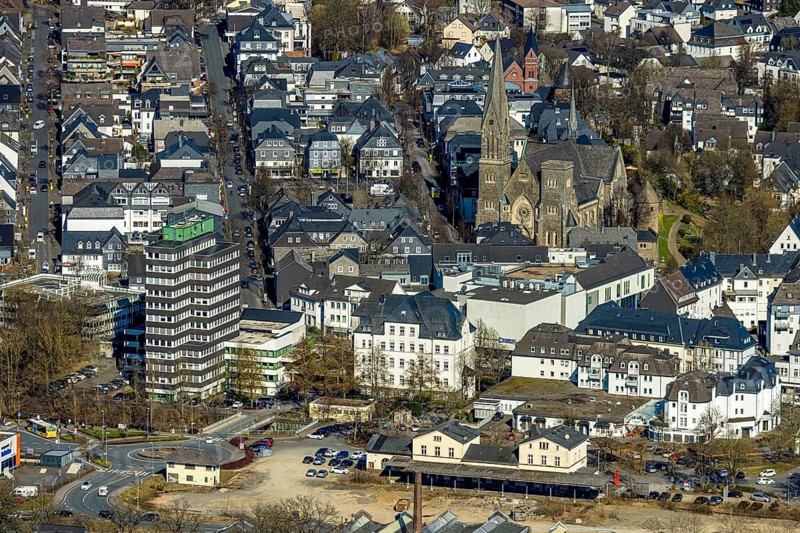 Aerial view, former Olpe railway station, left Olpe town hall, Altes Lyzeum (music school) and shopping centre, city and St. Martinus catholic church, roundabout Stellwerkstraße, Olpe city, Olpe, Sauerland, North Rhine-Westphalia, Germany, place of worship, authority, DE, Europe, religious community, place of worship, holy place, church, parish, denomination, aerial view, aerial photography, aerial photography, religion, religious site, overview, bird's eye view, birds-eyes view, overview
