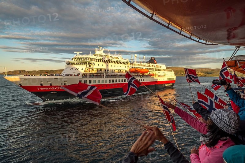 Tourists at the ship's railing, ship MS Finnmarken, Norwegian flags, Mehamn, Finnmark, Norway, Scandinavia, Europe, adventure trip, welcoming the passengers, tourism, Hurtigruten, Hurtigruten trip, cruise, cruise ship, liner, NOR, passenger ship, shipping company Hurtigruten AS, travel, destination, shipping, sea trip, sightseeing, tourism, Norwegian, Norwegian flag, Scandinavian, touristic
