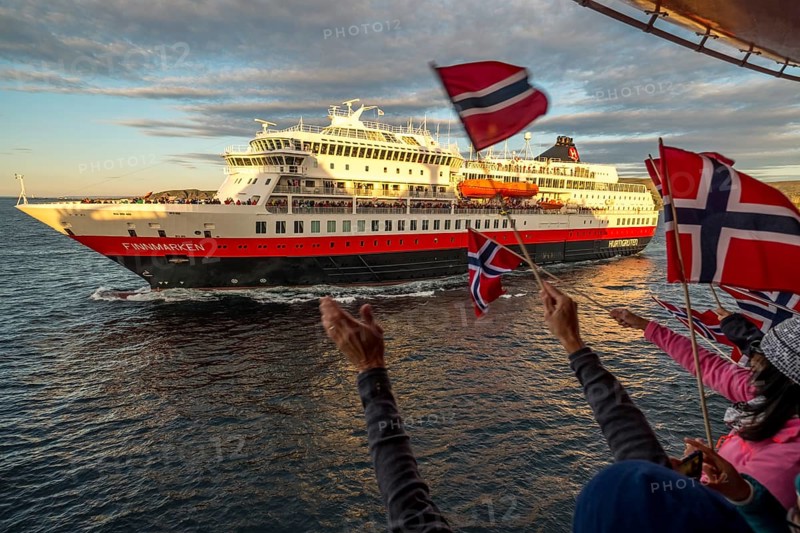 Tourists at the ship's railing, ship MS Finnmarken, Norwegian flags, Mehamn, Finnmark, Norway, Scandinavia, Europe, adventure trip, welcoming the passengers, tourism, Hurtigruten, Hurtigruten trip, cruise, cruise ship, liner, NOR, passenger ship, shipping company Hurtigruten AS, travel, destination, shipping, sea trip, sightseeing, tourism, Norwegian, Norwegian flag, Scandinavian, touristic