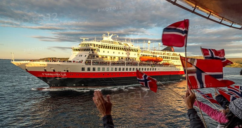 Tourists at the ship's railing, ship MS Finnmarken, Norwegian flags, Mehamn, Finnmark, Norway, Scandinavia, Europe, adventure trip, welcoming the passengers, tourism, Hurtigruten, Hurtigruten trip, cruise, cruise ship, liner, NOR, passenger ship, shipping company Hurtigruten AS, travel, destination, shipping, sea trip, sightseeing, tourism, Norwegian, Norwegian flag, Scandinavian, touristic