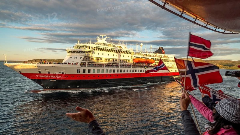 Tourists at the ship's railing, ship MS Finnmarken, Norwegian flags, Mehamn, Finnmark, Norway, Scandinavia, Europe, adventure trip, welcoming the passengers, tourism, Hurtigruten, Hurtigruten trip, cruise, cruise ship, liner, NOR, passenger ship, shipping company Hurtigruten AS, travel, destination, shipping, sea trip, sightseeing, tourism, Norwegian, Norwegian flag, Scandinavian, touristic