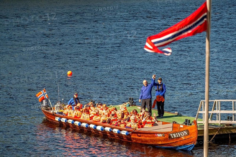 Norwegian flag, river cruise with tourists on an excursion boat, boat guide, Kirkenes, Finnmark, Norway, Scandinavia, Europe, adventure trip, excursion boat, boat trips, river boat, river cruise, tourism, Hurtigruten, Hurtigruten trip, cruise, NOR, trip, destination, sea trip, sightseeing, tourism, Trifon, Norwegian, Scandinavian, touristic