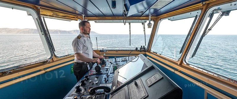 MS Polarlys, command bridge, officer on bridge, Honningsvåg, Finnmark, Norway, Scandinavia, Europe, adventure travel, tourism, Honningsvåg, Hurtigruten, Hurtigruten voyage, command post, cruise, cruise ship, NOR, navigation technology, travel, destination, ship, shipping, ship bridge, ship officer, sea voyage, sightseeing, controls, tourism, Norwegian, Scandinavian, touristic