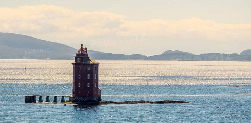 Kjeungskjær Fyr, red lighthouse, off the Norwegian coast on a small archipelago off Ã˜rland, Trø¸ndelag.Uthaug, Trø¸ndelag, Norway, Scandinavia, Europe, adventure travel, monument protection, fjord, tourism, Hurtigruten, Hurtigruten voyage, island, cruise, coast, coastal landscape, lighthouse, NOR, travel, destination, skerry, sea voyage, seabird sanctuary, sightseeing, tourism, Trøndelag, tower, Uthaug, octagonal, Norwegian, red colour, red facade, Scandinavian, touristy, Red Lighthouse, wooden lighthouse, historic lighthouse, landmark, landmarking