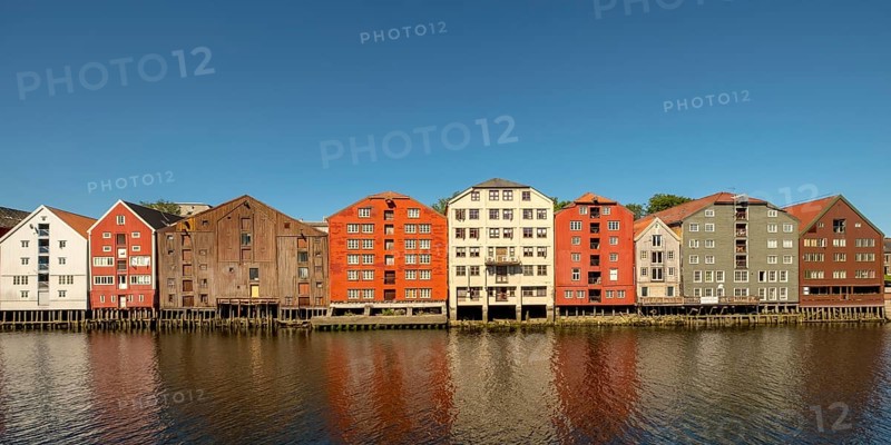 Warehouse city, picturesque colourful houses and commercial buildings on the river Nidelva, pile dwellings, Trondheim, Trøndelag, Norway, Scandinavia, Europe, adventure travel, tourism, gastronomy, commercial buildings, commercial district, property tax, commercial buildings, Hurtigruten, Hurtigruten trip, real estate, cruise, NOR, travel, destination, sea voyage, sightseeing, warehouses, tourism, Trøndelag, residential area, living and living, residential area, residential buildings, residential quality, residential quarter, housing estate, blue sky, colourful house facades, near the bridge Gamle Bybro, Norwegian, Scandinavian, touristy
