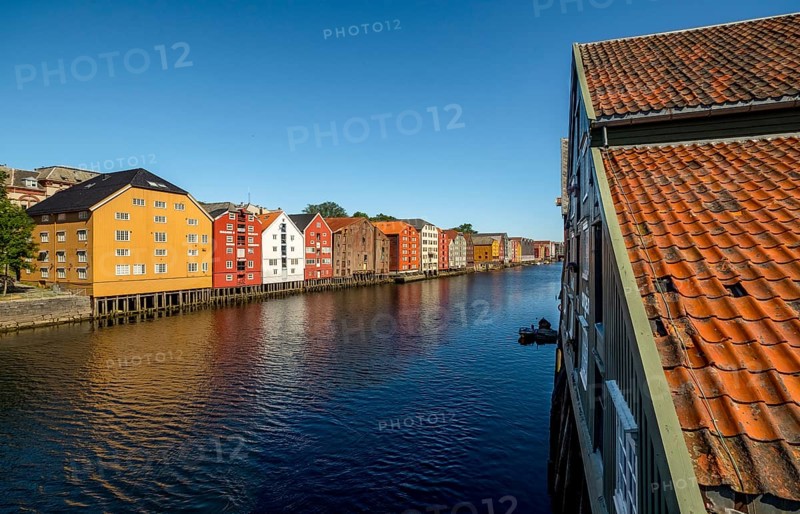 Warehouse city, picturesque colourful houses and commercial buildings on the river Nidelva, pile dwellings, Trondheim, Trøndelag, Norway, Scandinavia, Europe, adventure travel, tourism, gastronomy, commercial buildings, commercial district, property tax, commercial buildings, Hurtigruten, Hurtigruten trip, real estate, cruise, NOR, travel, destination, sea voyage, sightseeing, warehouses, tourism, Trøndelag, residential area, living and living, residential area, residential buildings, residential quality, residential quarter, housing estate, blue sky, colourful house facades, near the bridge Gamle Bybro, Norwegian, Scandinavian, touristy