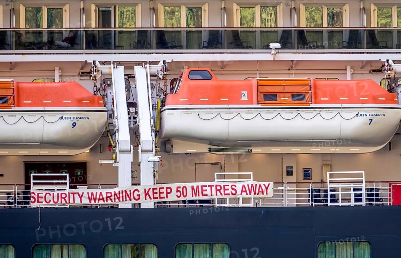 Ship RMS Queen Elizabeth, warning to sea pirates, security warning keep 50 metres away, lifeboats, Geiranger, Møre og Romsdal, Norway, Scandinavia, Europe, adventure travel, mountainside, tourism, Hurtigruten, Hurtigruten voyage, cabin window, cruise, cruise ship, Møre og Romsdal, NOR, passenger ship, shipping company Hurtigruten AS, travel, destination, Royal Mail Ship, ship, sea voyage, sightseeing, tourism, Norwegian, Scandinavian, touristic