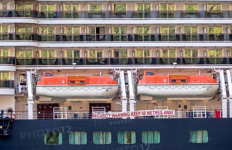 Ship RMS Queen Elizabeth, warning to sea pirates, security warning keep 50 metres away, lifeboats, Geiranger, Møre og Romsdal, Norway, Scandinavia, Europe, adventure travel, mountainside, tourism, Hurtigruten, Hurtigruten voyage, cabin window, cruise, cruise ship, Møre og Romsdal, NOR, passenger ship, shipping company Hurtigruten AS, travel, destination, Royal Mail Ship, ship, sea voyage, sightseeing, tourism, Norwegian, Scandinavian, touristic