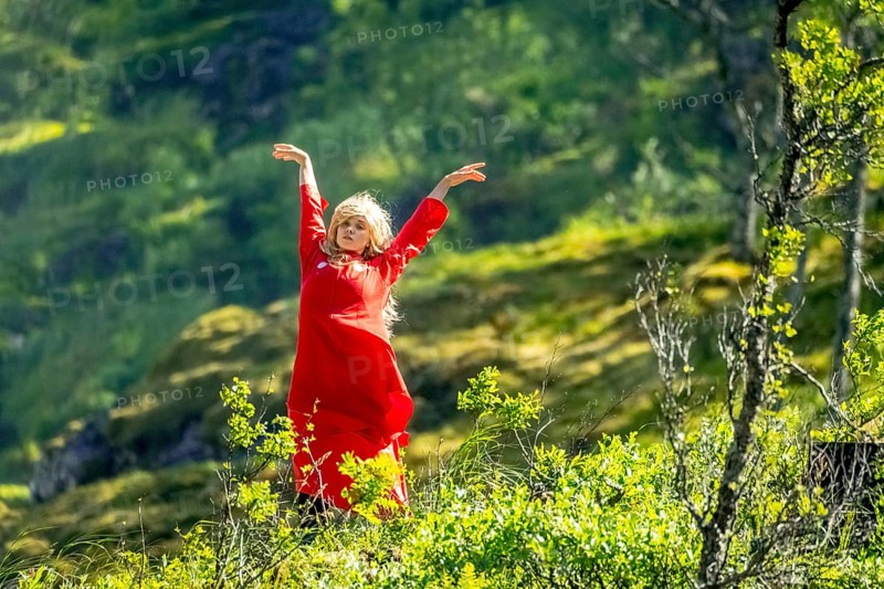 Woman dressed in red is a Huldra, fairy, legendary figure, Kjosfossen waterfall, waterfall near Fureberget, dancer in red dress, rock faces, Flåm, Sogn og Fjordane, Norway, Scandinavia, Europe, Flåm, NOR, travel, tourism, destination, sightseeing, sea voyage, Hurtigruten, Hurtigruten trip, tourism, Norwegian, Scandinavian, touristic, cruise, adventure trip, waterfall, waterfall, mountains, trees, meadows, Flamsbahn, Flamsbana, train journey, tour, travel with the Flam Railway, Flam Railway