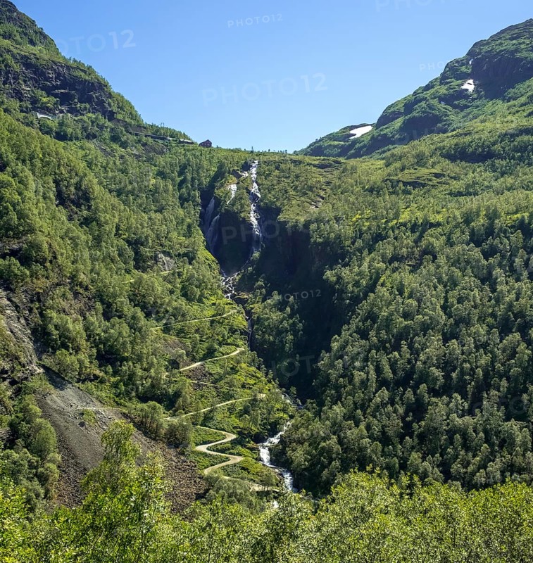 Kjosfossen waterfall, waterfall near Fureberget, mountain, forest, road, sky Flåm, Sogn og Fjordane, Norway, Scandinavia, Europe, Flåm, NOR, travel, tourism, destination, sightseeing, sea voyage, Hurtigruten, Hurtigruten trip, tourism, Norwegian, Scandinavian, touristic, cruise, adventure trip, waterfall, mountains, rock faces, trees, roads, train journey, tour, travel by Flam Railway, Flam Railway