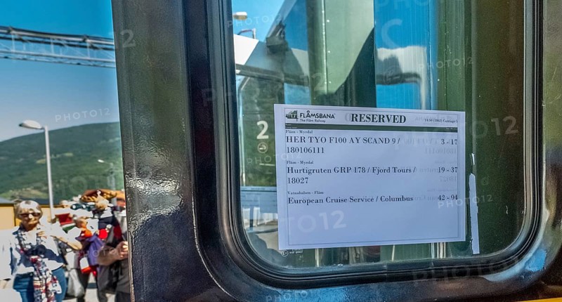 Travel on the Flam Railway, iron railway journey, Flam Railway reservation information sheet, train window, Flåm, Sogn og Fjordane, Norway, Scandinavia, Europe, Flåm, NOR, travel, tourism, destination, sightseeing, sea voyage, Hurtigruten, Hurtigruten voyage, tourism, Norwegian, Scandinavian, tourist, cruise, adventure travel