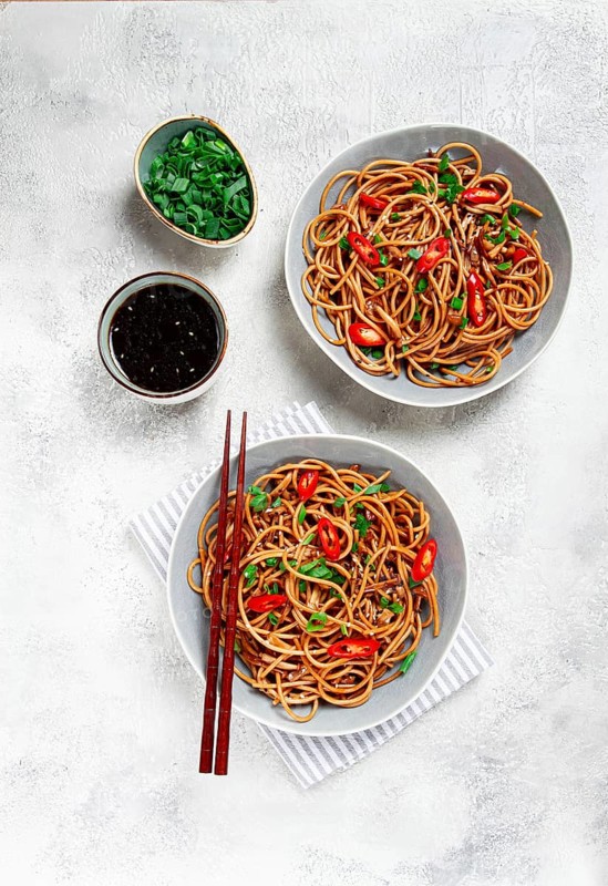 Udon noodles, with shimeji mushrooms, vegetables, in sauce, with sesame seeds, green onions, Asian vegetarian food, horizontal, without people