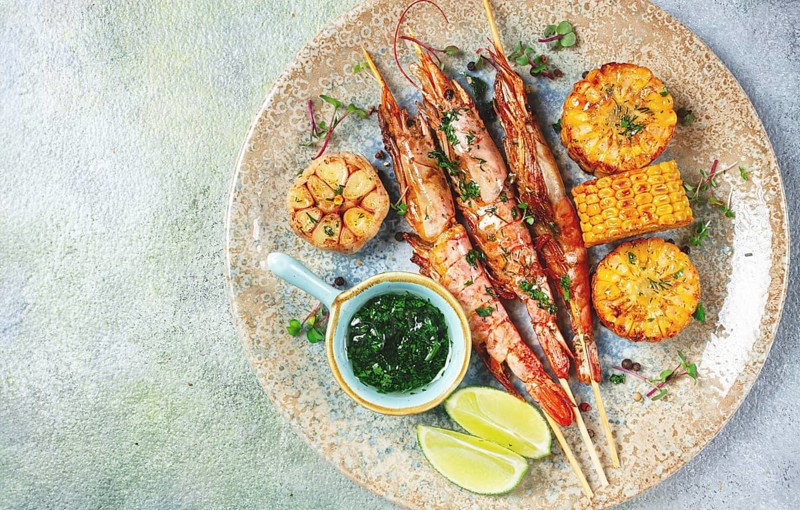 Langoustines on skewers, shrimp kebab, with fried corn, spices and herbs, homemade, no people