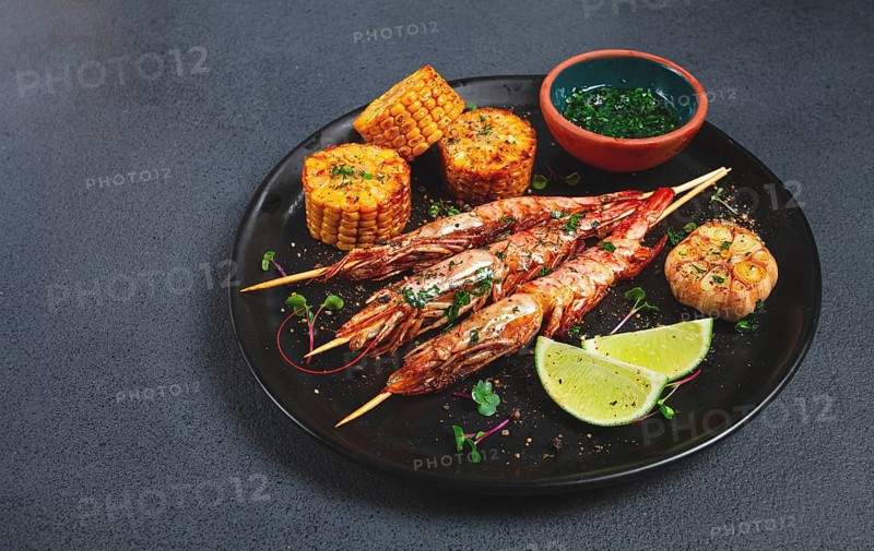 Langoustines on skewers, shrimp kebab, with fried corn, spices and herbs, homemade, no people