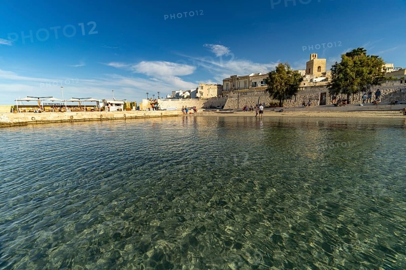 City beach Spiaggetta del Molo or Spiaggia dei Bambini and the old town centre of Otranto, Apulia, Italy