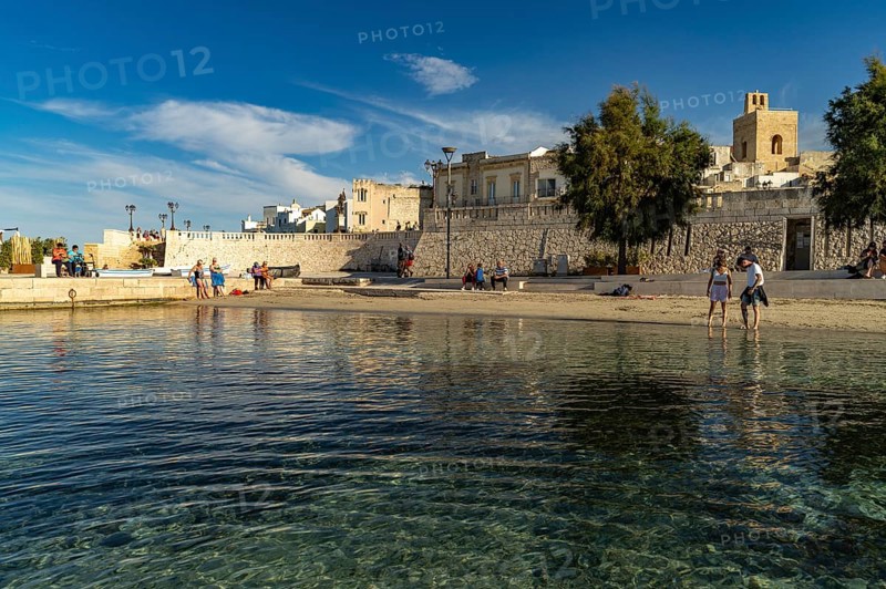 City beach Spiaggetta del Molo or Spiaggia dei Bambini and the old town centre of Otranto, Apulia, Italy
