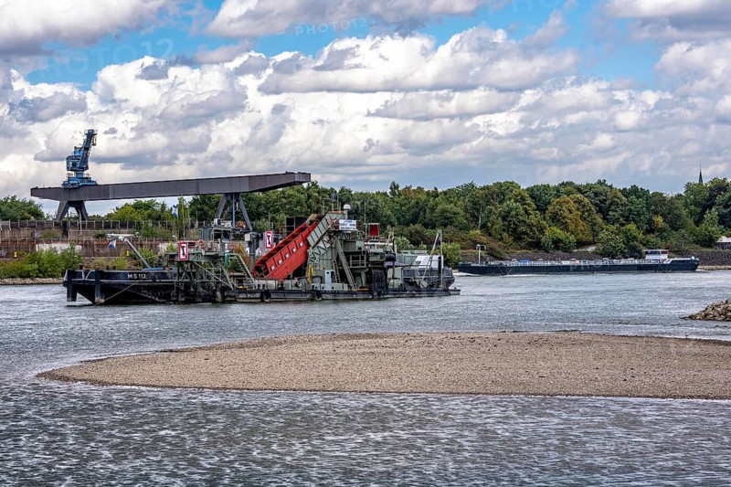 Bucket chain dredger at work on the Rhine near Duisburg, between the Neuenkamper Rhine Bridge and the Friedrich-Ebert Bridge in Ruhrpott, dredging the navigation channel, North Rhine-Westphalia, Germany